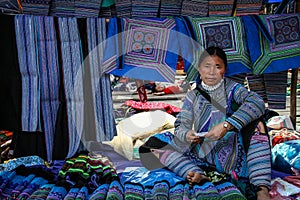 Flower hmong woman selling the traditional fabrics at the Bac Ha Market, Lao Cai, Vietnam
